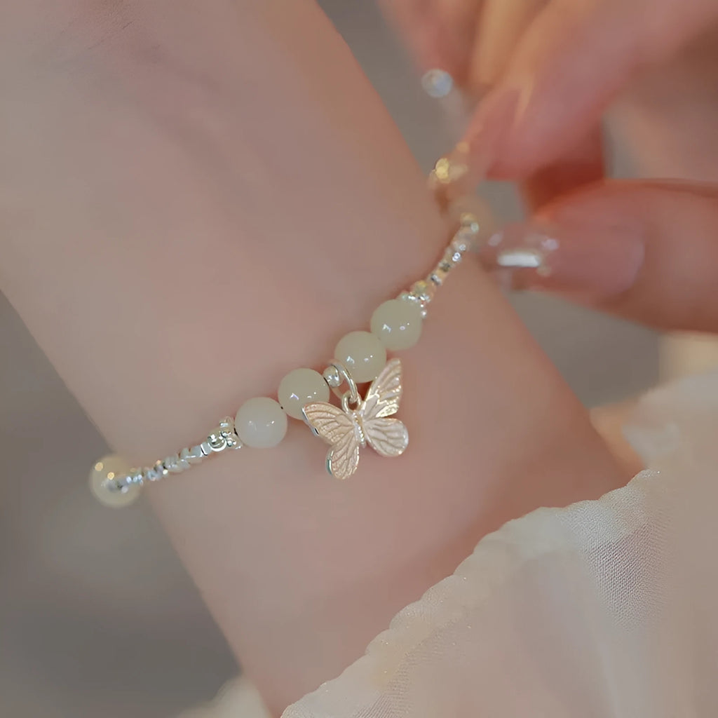 Silver butterfly jewellery set with hetian jade accents showing bracelet and necklace combination