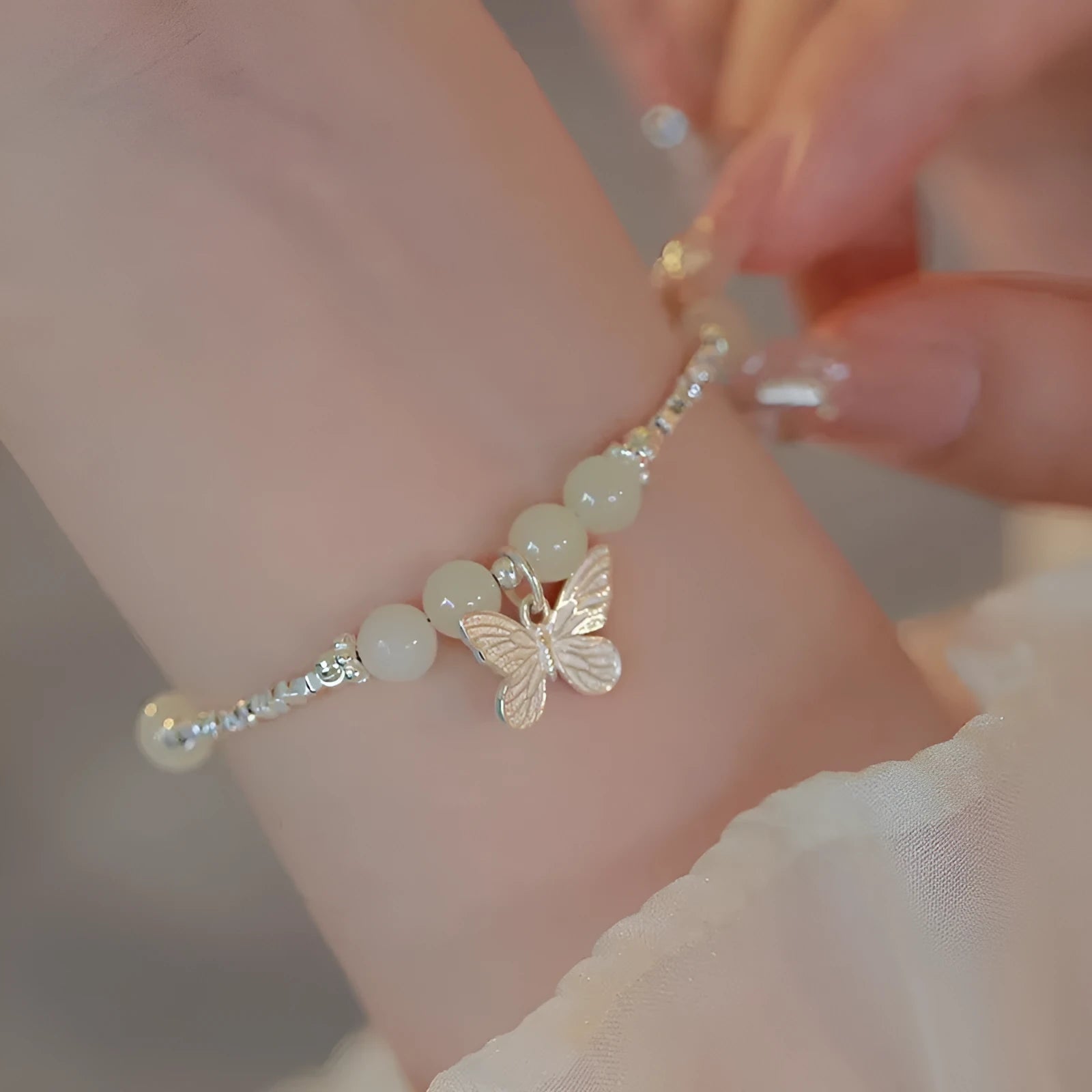 Silver butterfly jewellery set with hetian jade accents showing bracelet and necklace combination