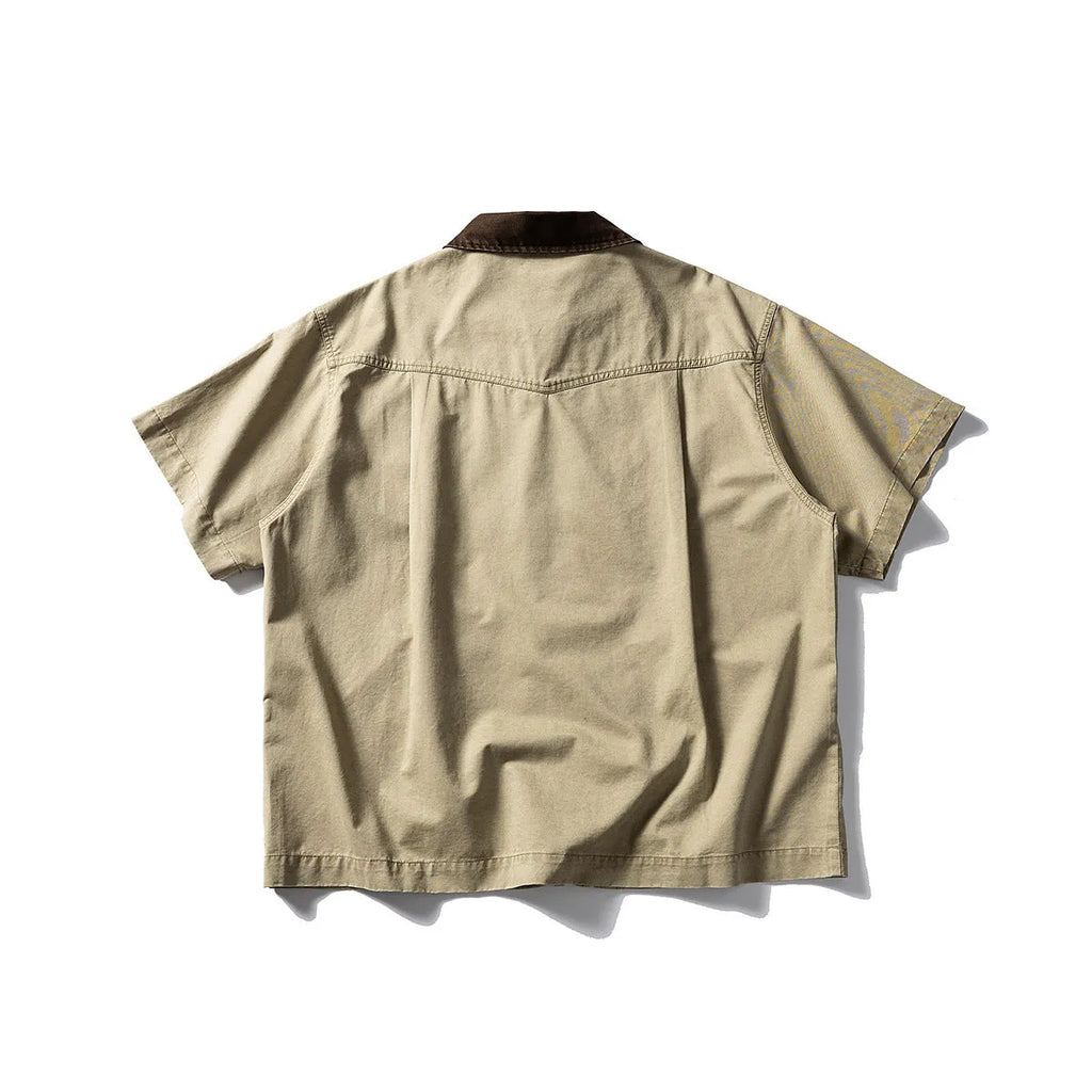 Man wearing a grey washed cotton short sleeve loose cardigan shirt.