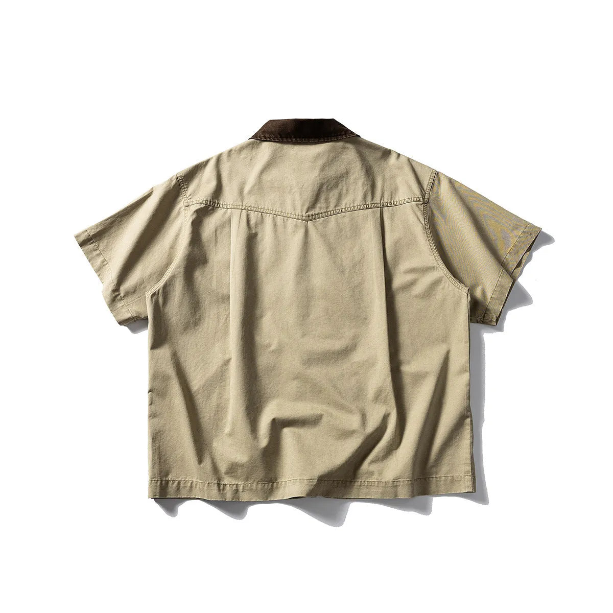 Man wearing a grey washed cotton short sleeve loose cardigan shirt.