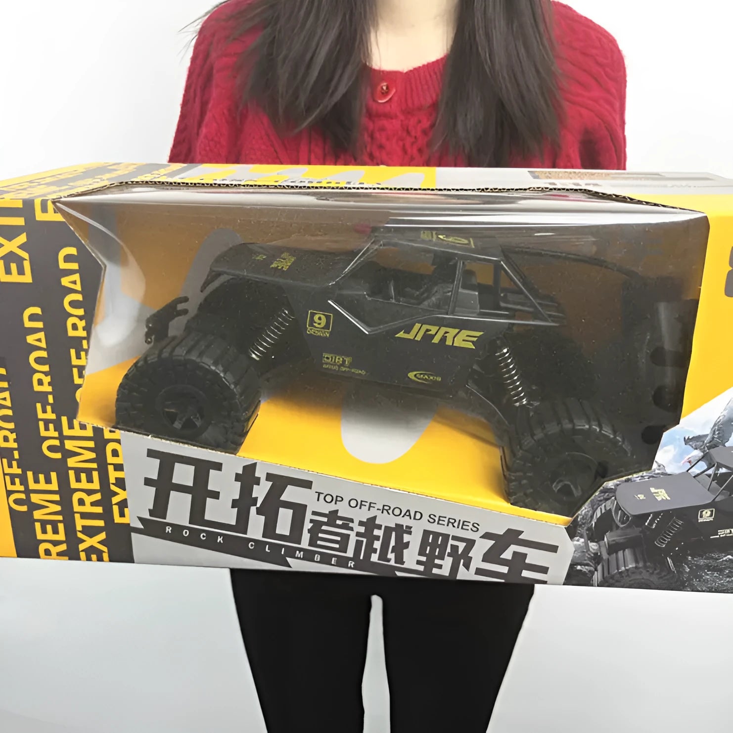 Super large black remote control off-road toy car with four-wheel drive and spring rod design on outdoor ground