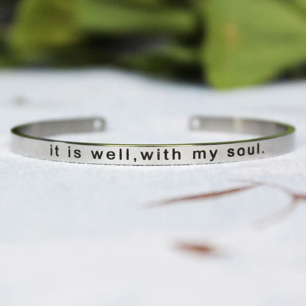 Silver customisable stainless steel bracelet with laser engraved text and adjustable fit on neutral background