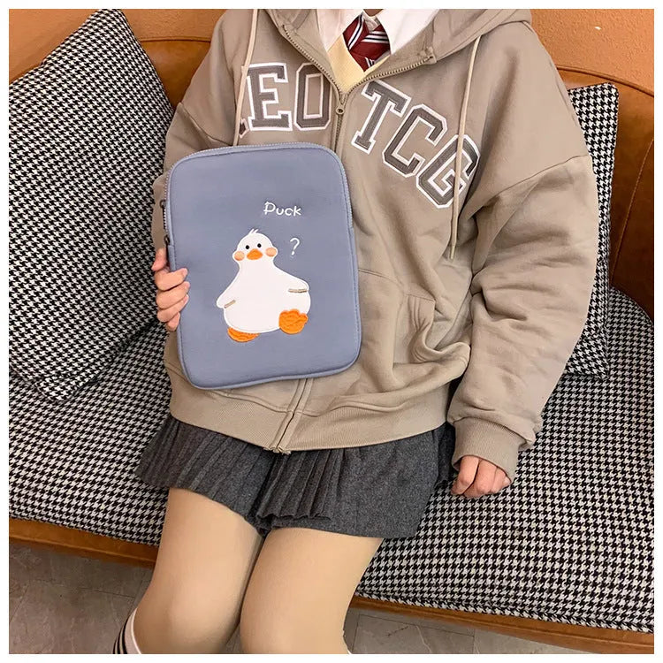 Blue cotton tablet case with embroidered cartoon duck design and zipper closure.