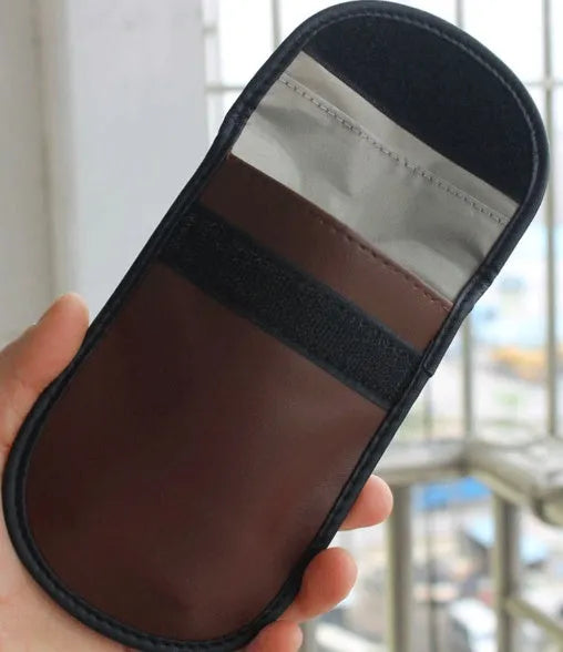 Black microfiber RFID signal blocker bag measuring 13.5 by 9.5 centimetres.