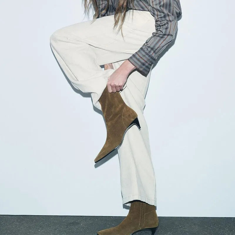 Brown square toe ankle boots with a side zip and a mid kitten heel on a plain background.