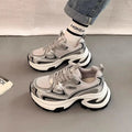 Women's red clunky platform sneakers with mesh lining and rubber sole on a white background.