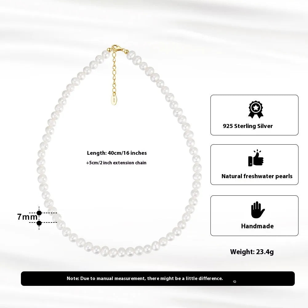 Women's silver necklace with round freshwater pearls on an adjustable chain.