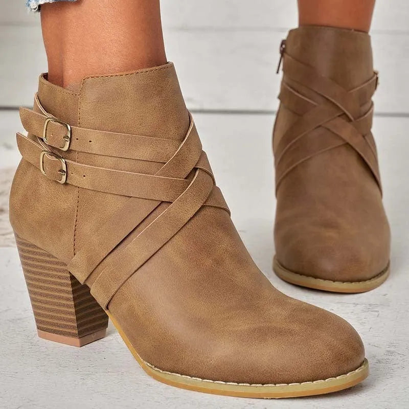 Women's grey short ankle boots with a block heel, side zipper, and buckle strap on a white background.