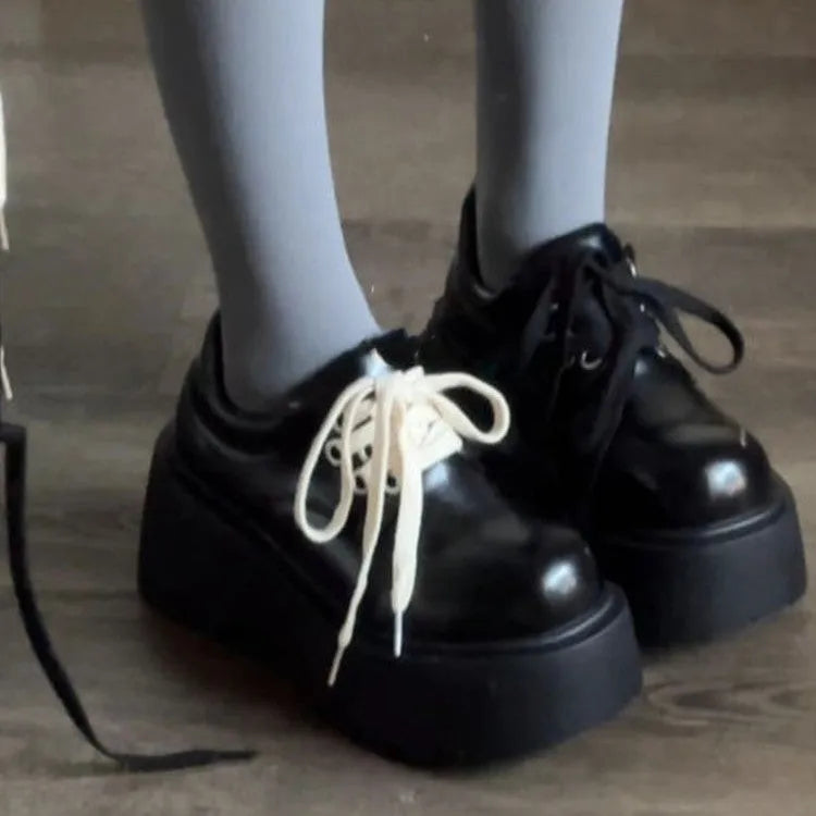 Matte black women's lace-up boots with thick rubber sole and English muffin heel