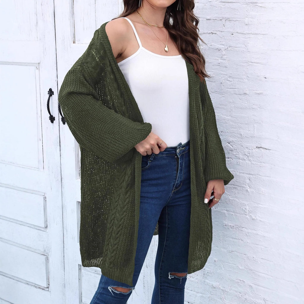 Women's loose brown acrylic sweater coat hanging, showing solid colour and knit texture.