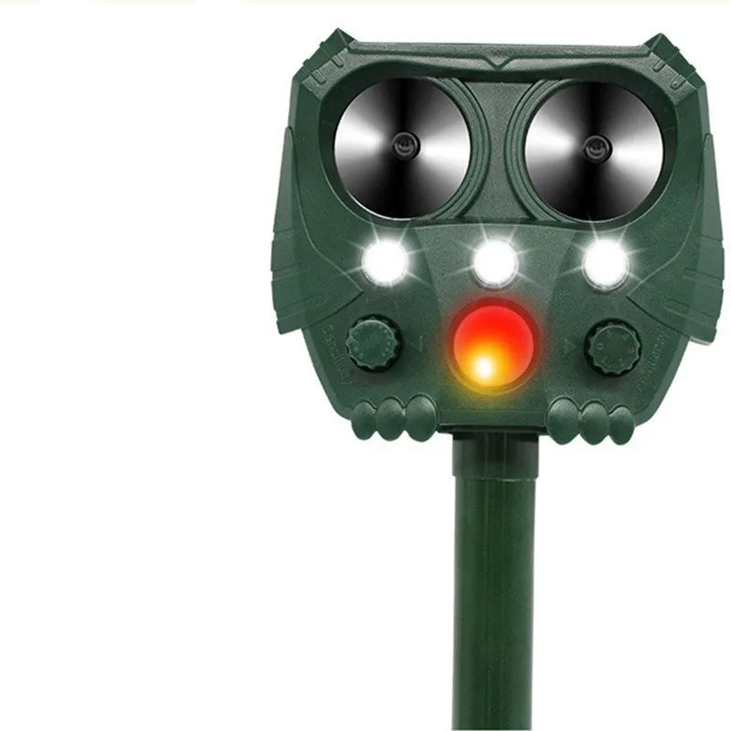 Green solar ultrasonic animal repeller with solar panel on top for outdoor pest control