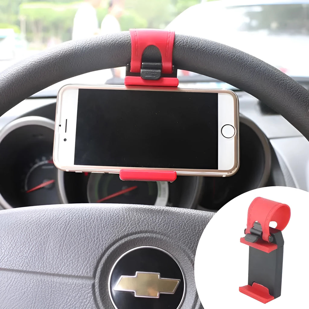 Black universal steering wheel phone holder clip mounted on a car steering wheel holding a smartphone.