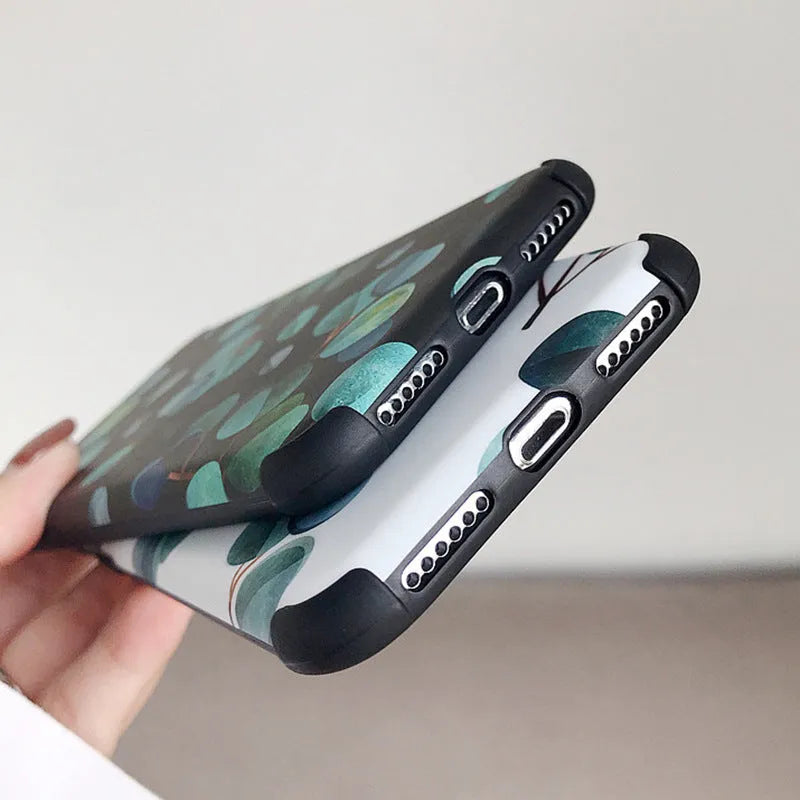 Black silicone iPhone case with a detailed leaf pattern design on the back.