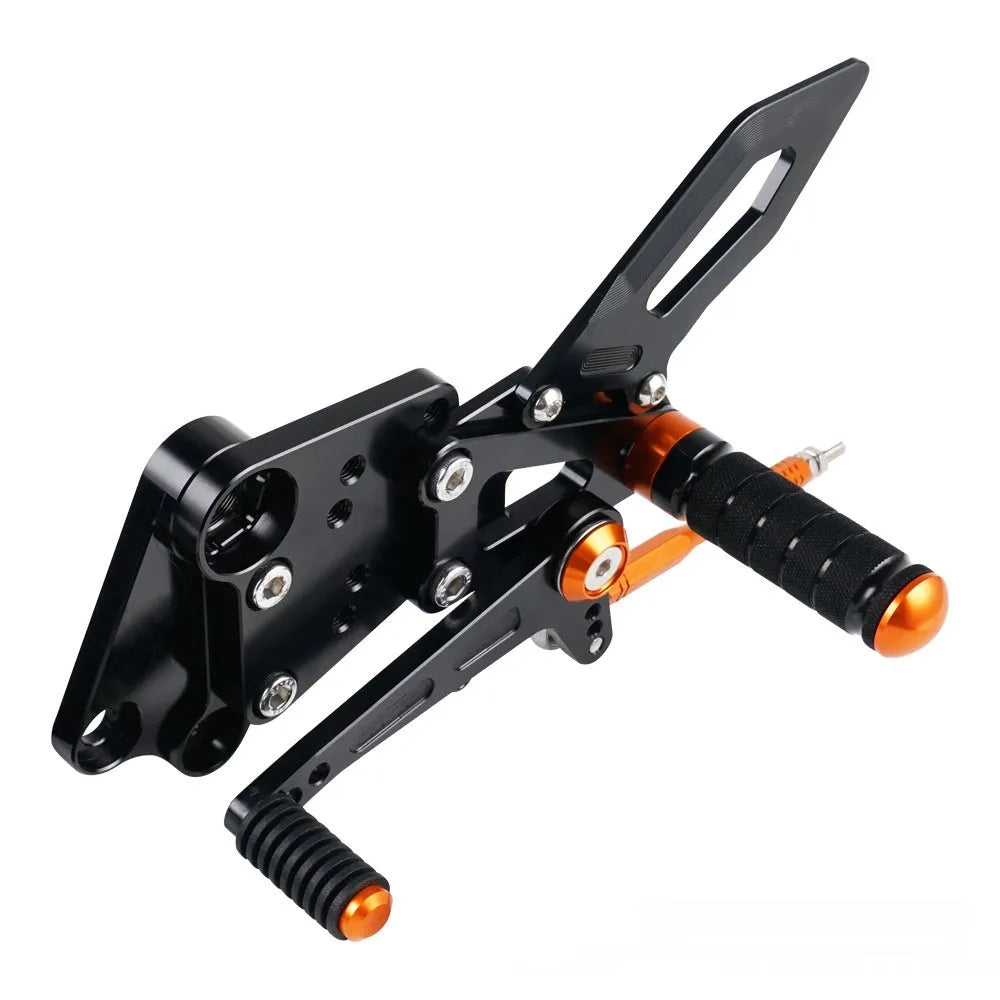 Black and orange KTM Duke motorcycle pedal support bracket assembly