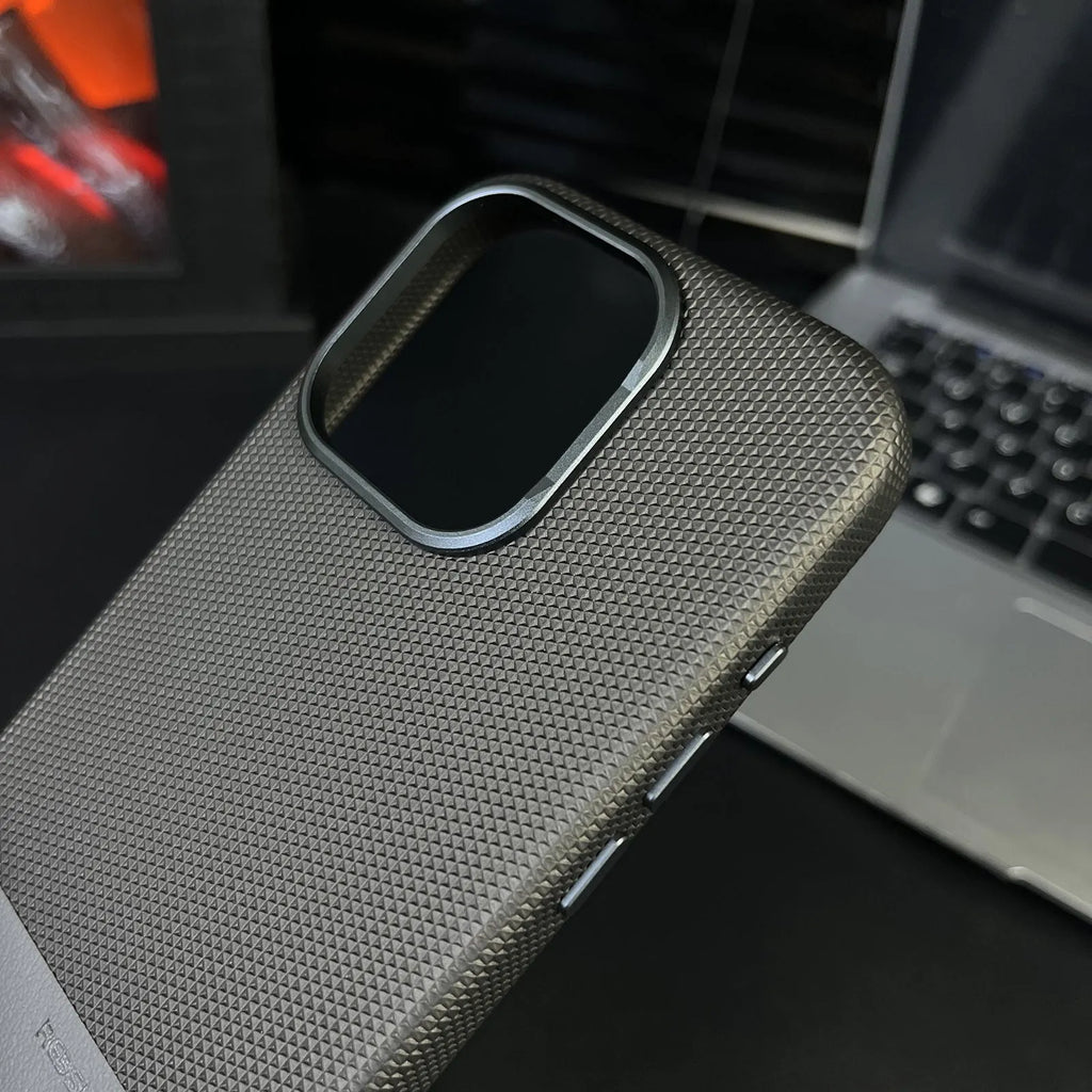 Black magnetic iPhone case with dragon scale texture and stitching, shown on an iPhone 15 Pro.
