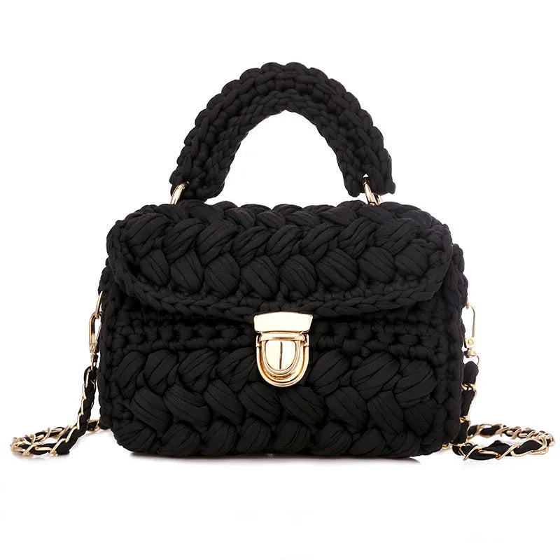 Hand knitted crochet tote crossbody bag in cotton with lock closure, yellow colour, on a plain background
