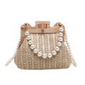 Women's woven straw shoulder bag with pearl chain strap showing interior organisation compartments