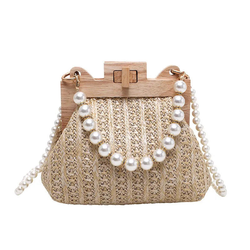 Women's woven straw shoulder bag with pearl chain strap showing interior organisation compartments