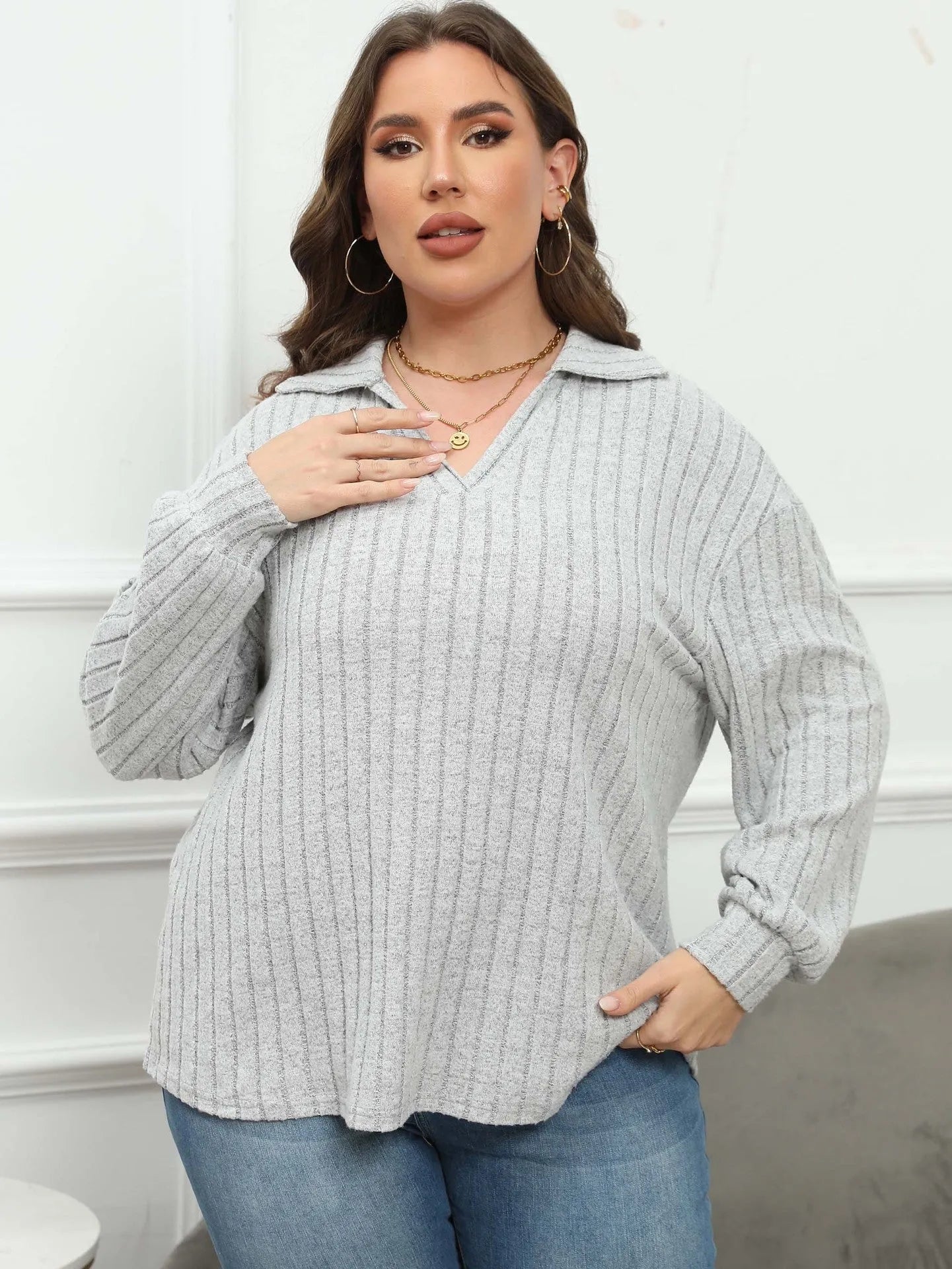 Women's plus size grey polo collar fleece shirt with lantern sleeves on a hanger.