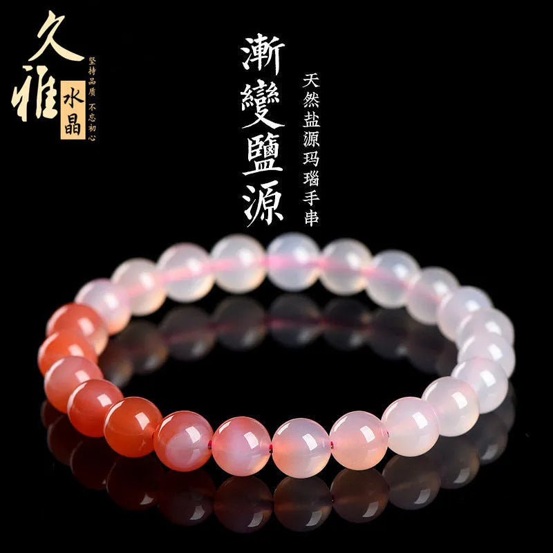 A gradient coloured Yanyuan agate bracelet with polished geometry-shaped beads on a white background.