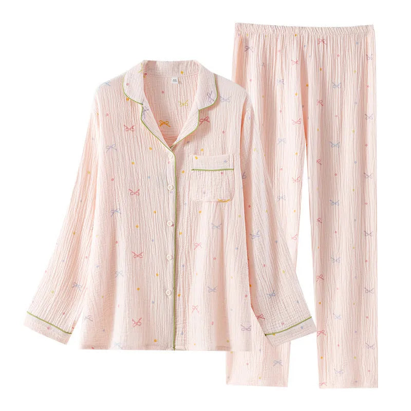 Women's cotton pajama set with long sleeves in pink colour showing top and trousers laid flat