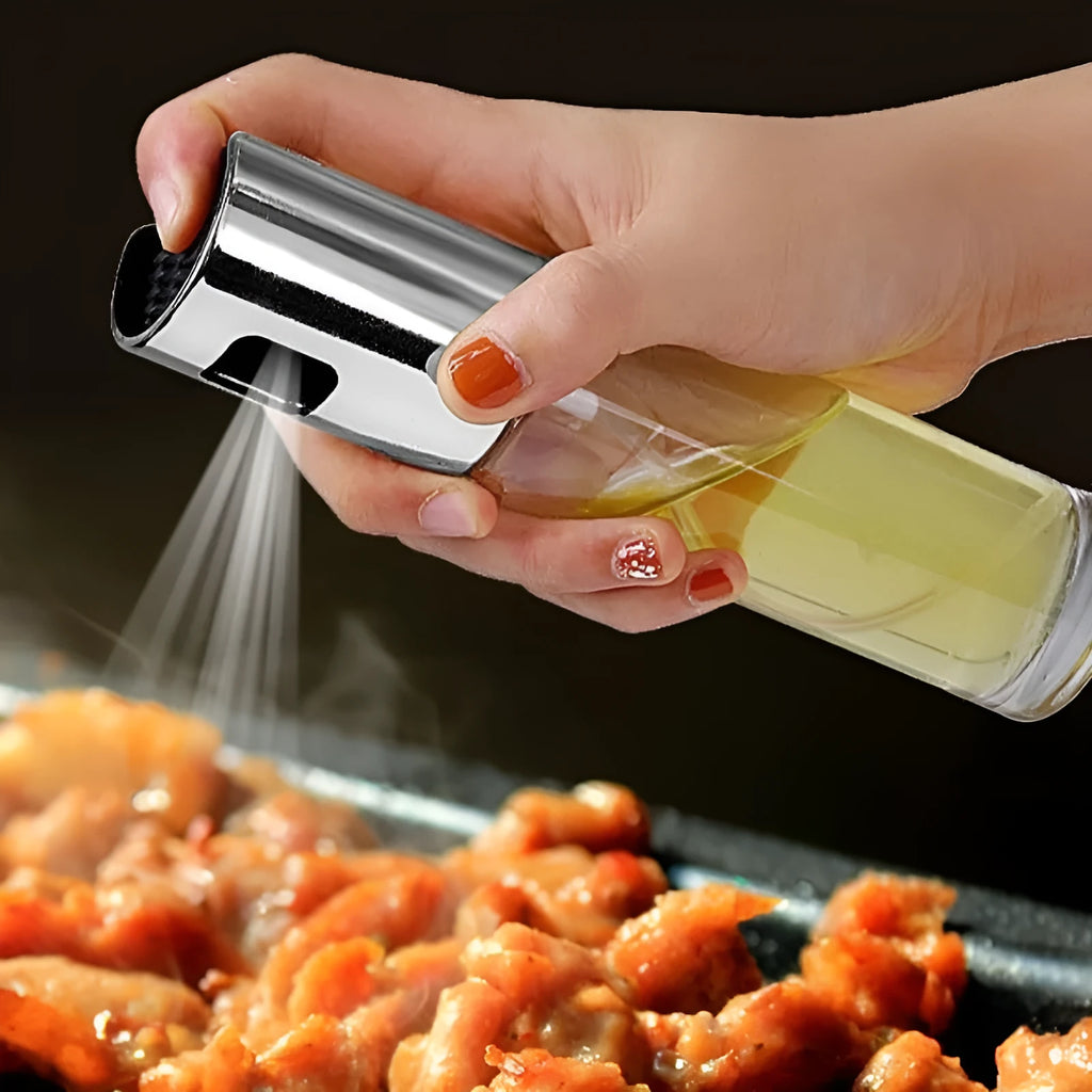 Gold push-type oil and vinegar spray bottle made of ABS plastic and glass with pump top.
