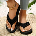 Black women's flat slippers with a cotton cloth upper and a solid sole, shown in a casual style.