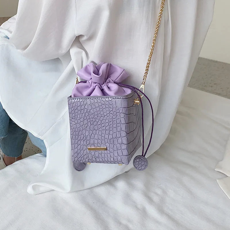 Small Korean-style women's messenger bag with chain strap in various plain colours.