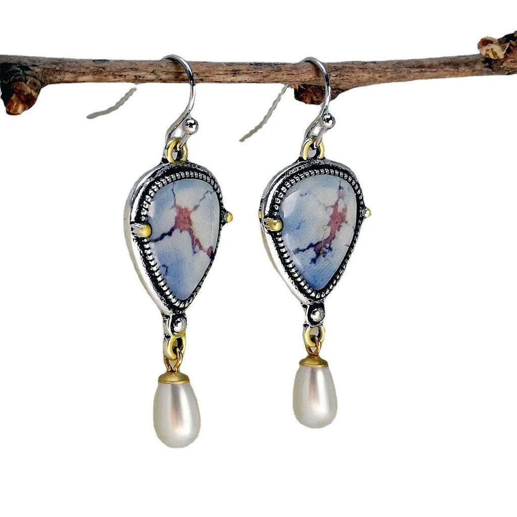 Blue retro bohemian drop earrings with synthetic opal and pearl details on electroplated metal