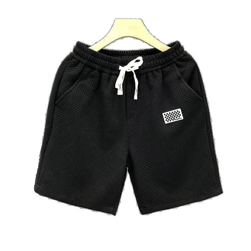 Men's solid colour polyester sports shorts on a hanger, showing elastic waistband.