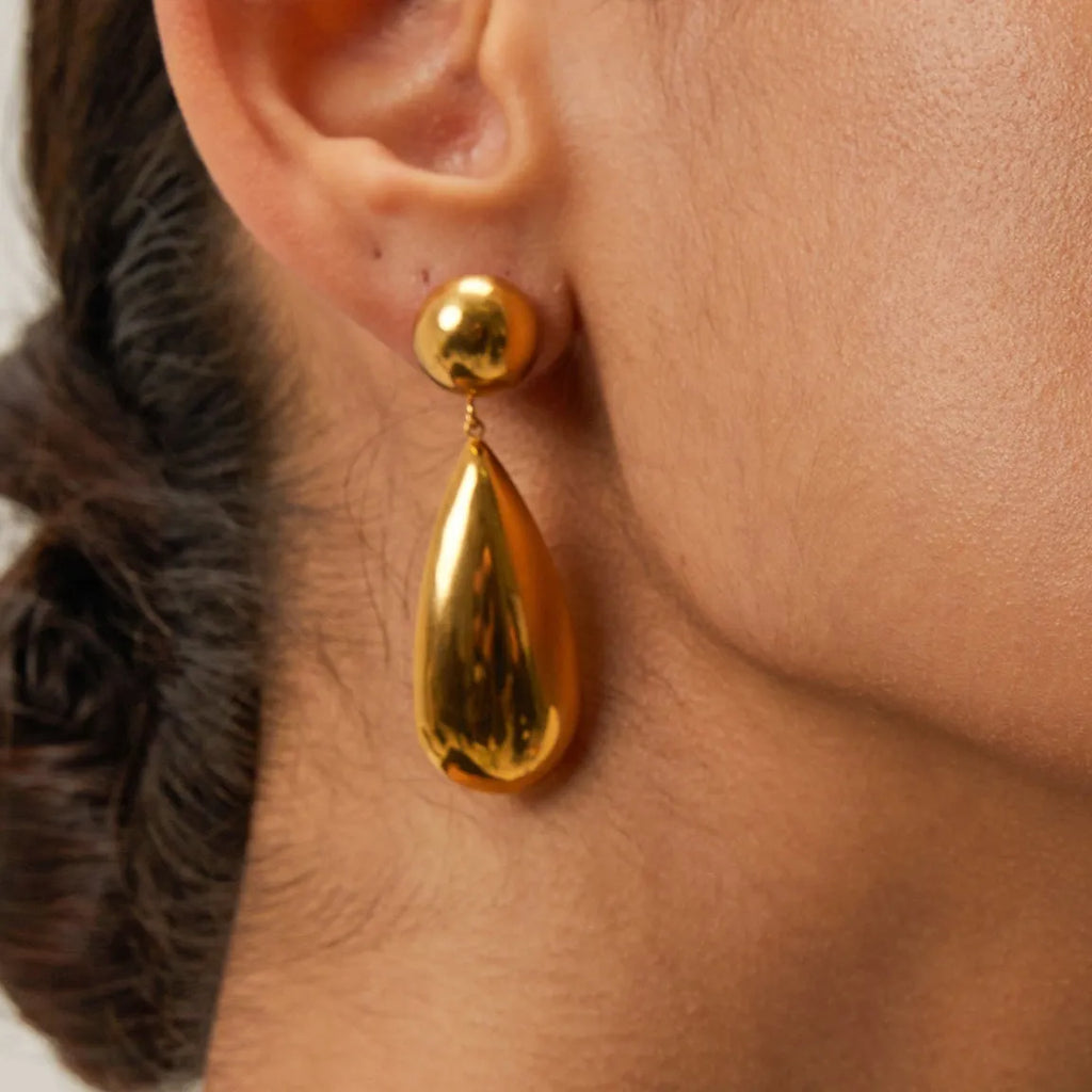 Gold electroplated stainless steel water droplet earrings with geometric hemisphere pendant design