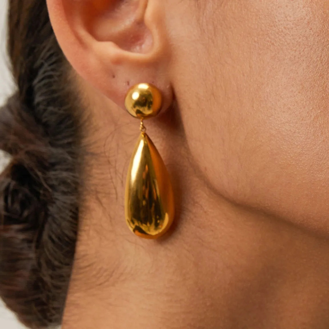 Gold electroplated stainless steel water droplet earrings with geometric hemisphere pendant design