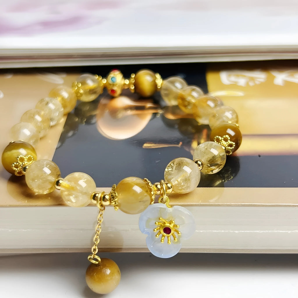 Golden yellow citrine crystal bracelet with flower and tassel detail for women.