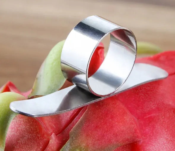Silver stainless steel finger ring fruit peeler for citrus and pomegranates.
