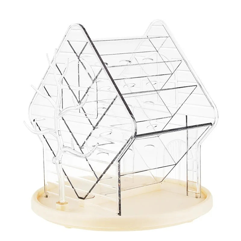 A clear and an amber gold rotating plastic cosmetics storage box on a dressing table.