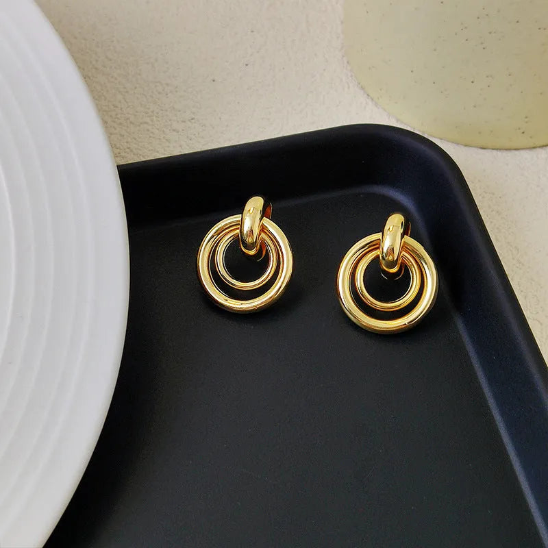 Geometric round ring earrings with irregular design in gold and silver electroplated finishes