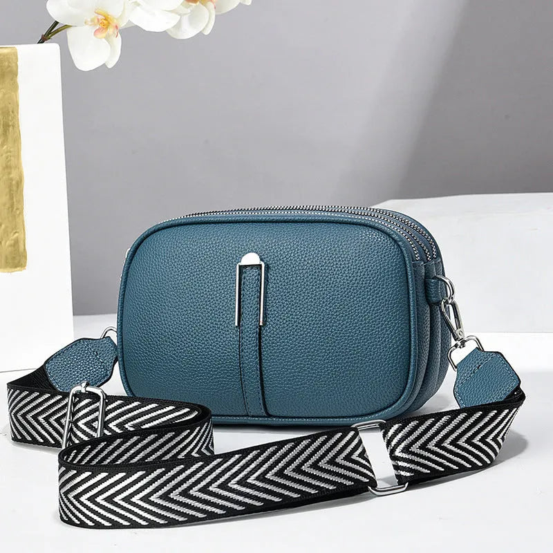 Soft PU leather women's oval crossbody bag showing slit pocket and internal organiser compartments