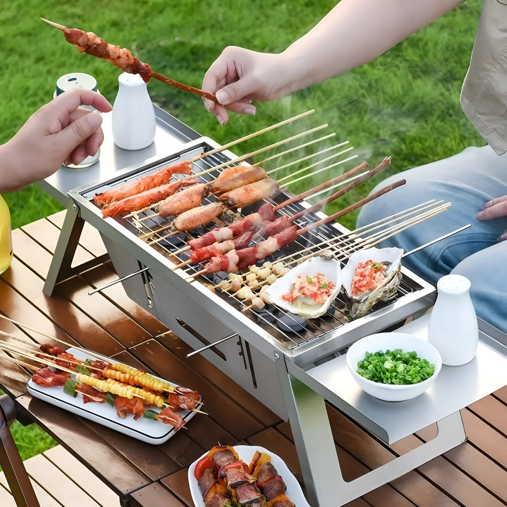 Small foldable portable charcoal grill for outdoor cooking.