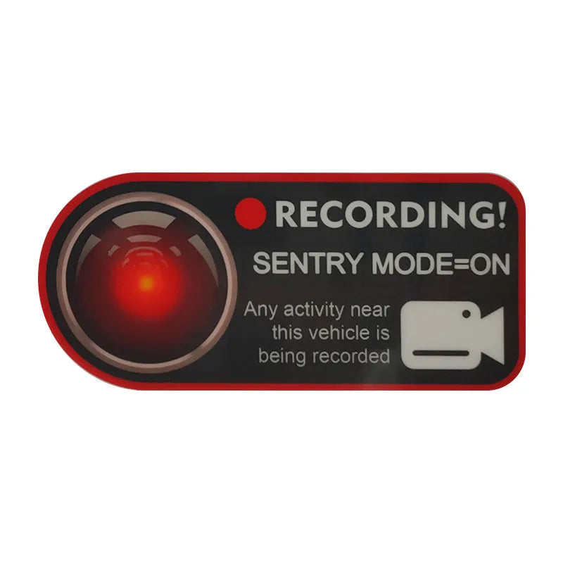 Pair of white rectangular Tesla Sentry Mode warning stickers with black text, 11cm by 5cm.