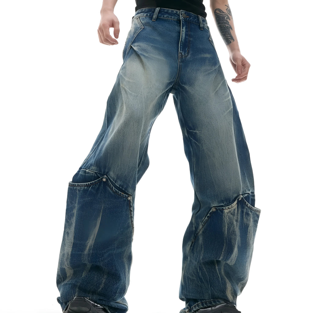 Men's verdant blue jeans with a retro washed burst pattern and curved knife details, shown in a loose fit.