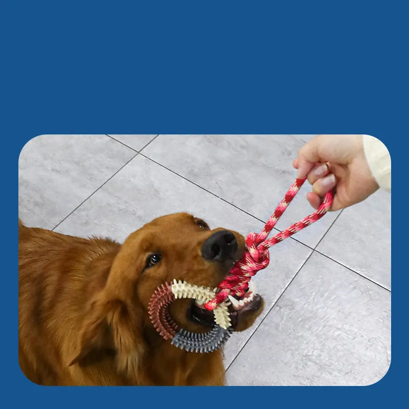 Blue braided rope dog chew toy with a large central knot on a wooden floor