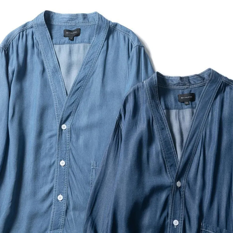 Men's dark blue denim coat with three-quarter sleeves and V-neck collar showing front pocket detail
