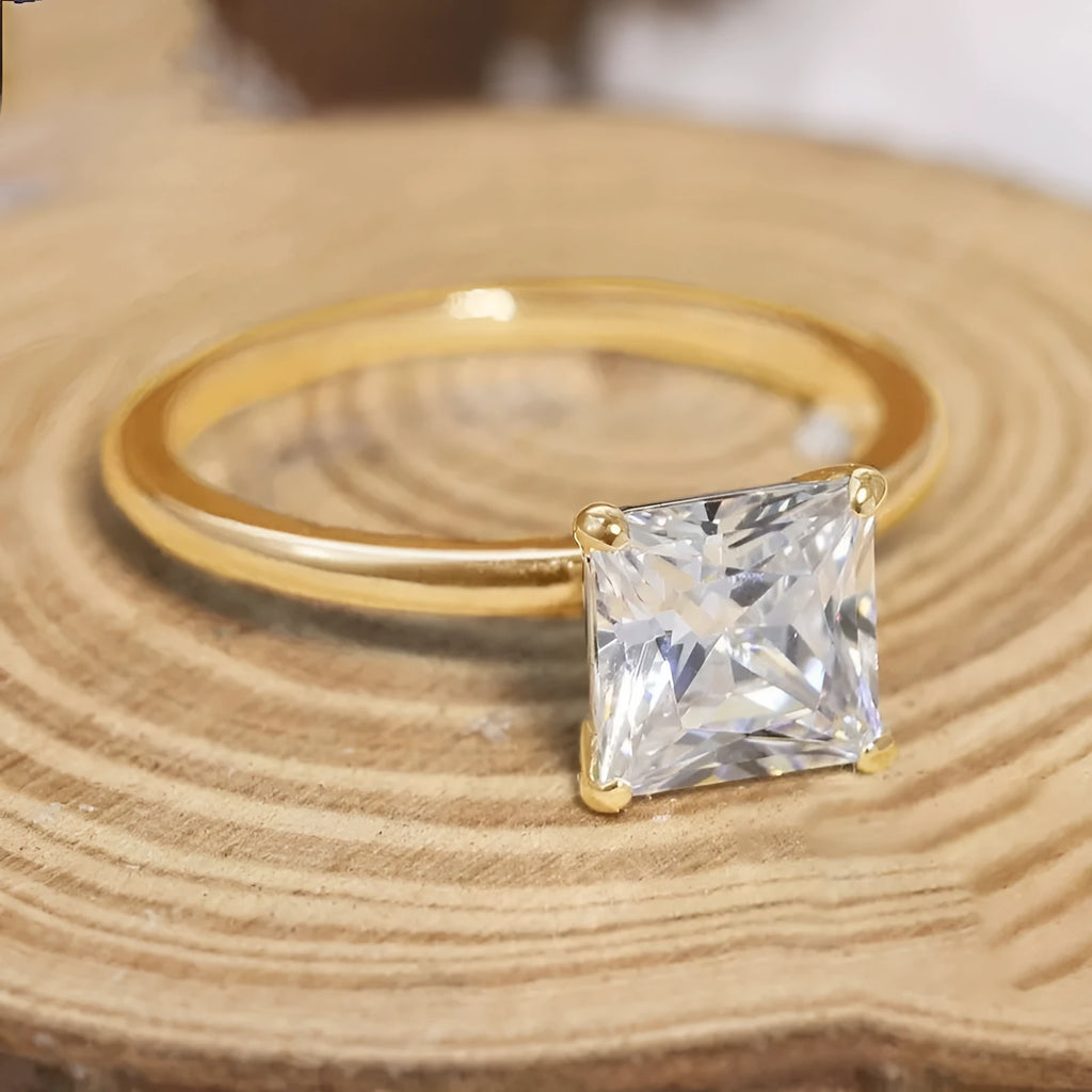 Women's simple geometric 925 sterling silver ring in gold, rose gold, or silver colour on a grey background.