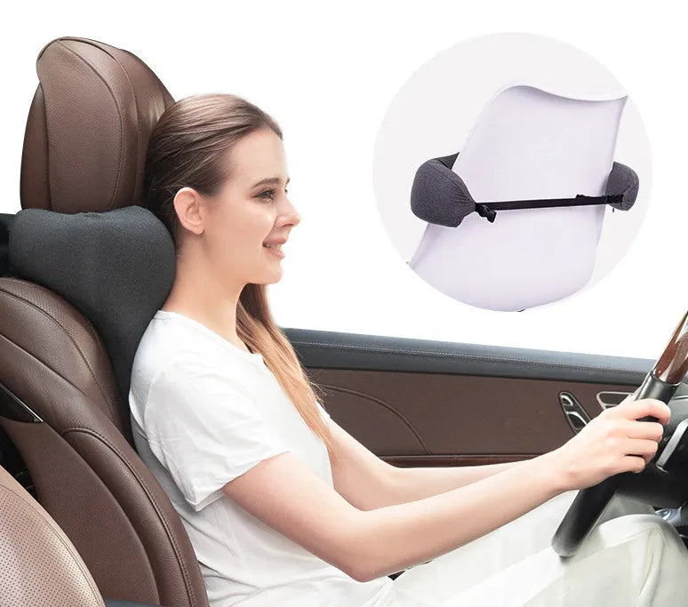 Dark gray universal car neck memory foam pillow on a car seat headrest.