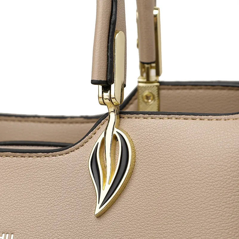 Women's black PU leather shoulder messenger bag with visible stitching and multi-layer interior.