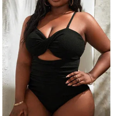 Women's plus size black one-piece swimsuit with sleeveless design on mannequin