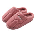 Unisex plush house slippers with white honeycomb-patterned PVC sole, showing round toe and plush inner lining in purple colour