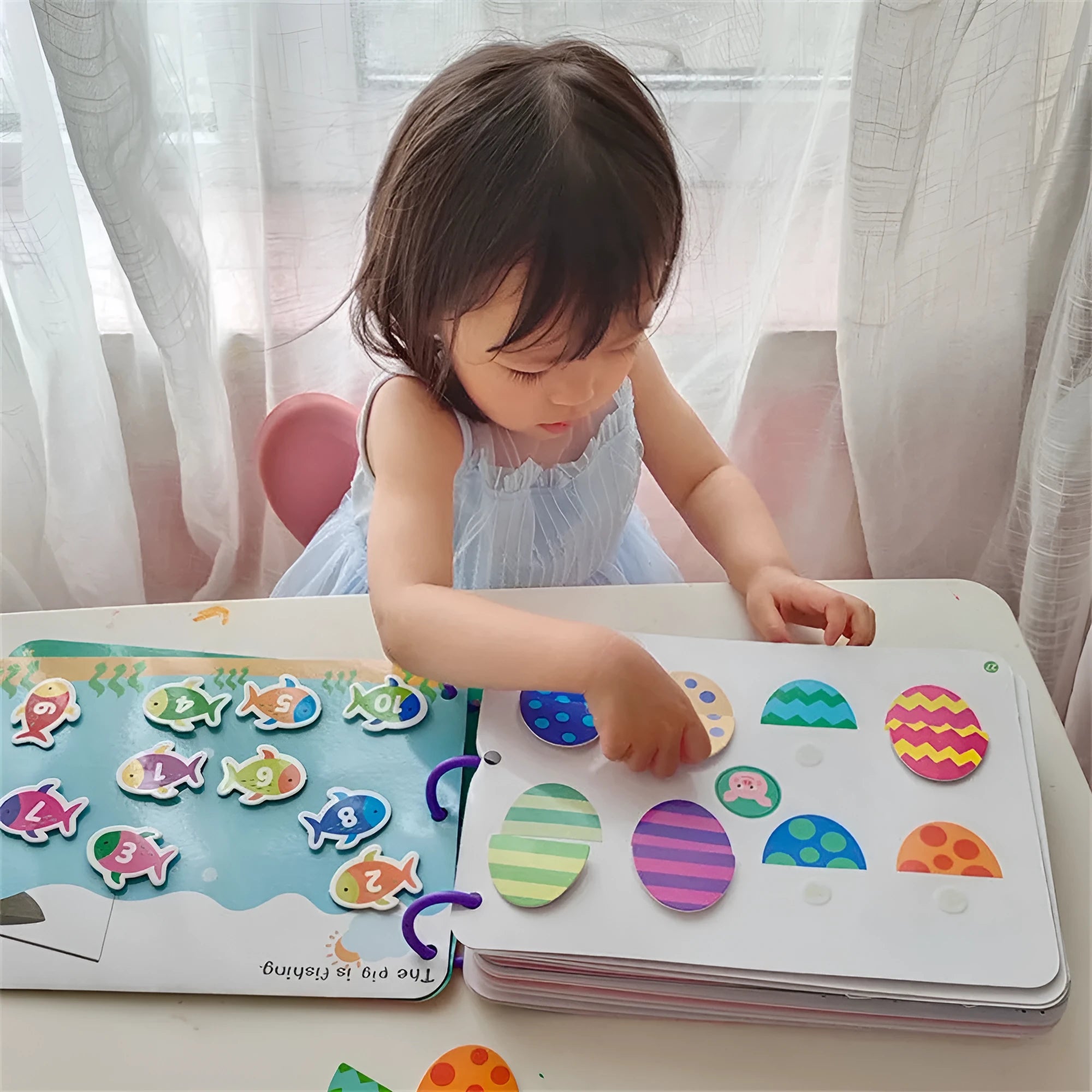 Montessori paste quiet book with metal build, showing themed pages for infant learning