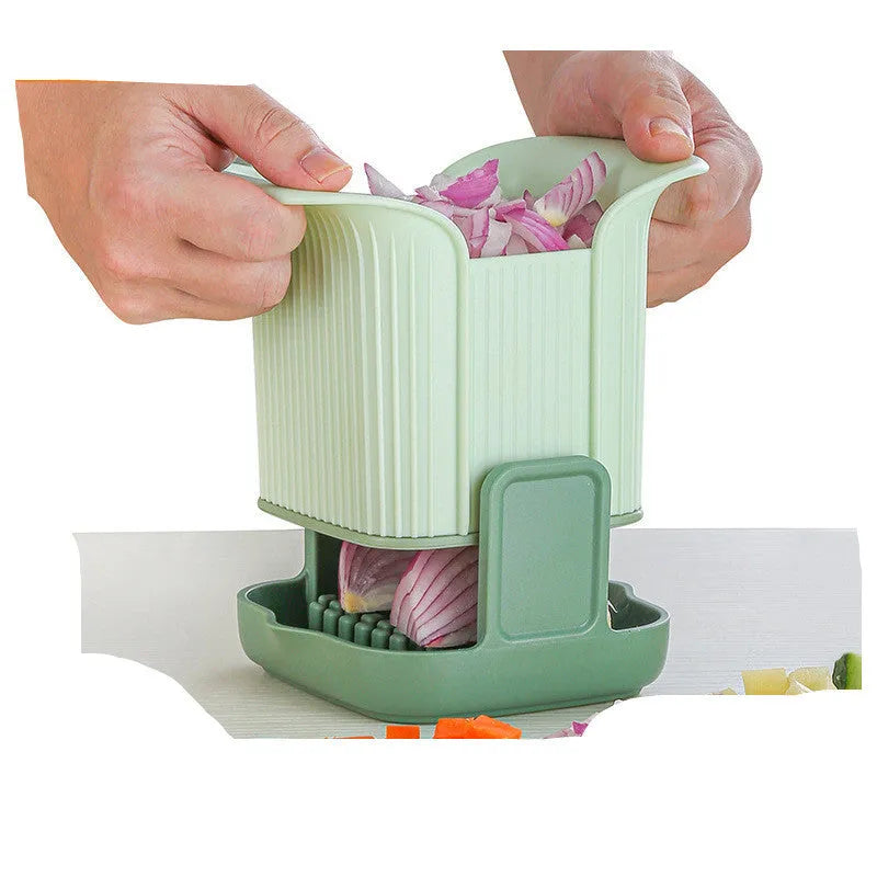 Green hand-operated vegetable chopper with stainless steel blades for slicing onions, potatoes, radishes and cucumbers