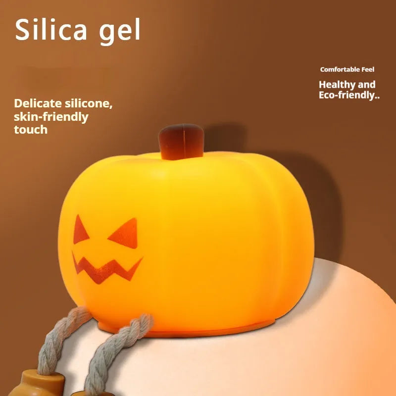 Soft orange silicone pumpkin-shaped night light with a warm glowing LED centre